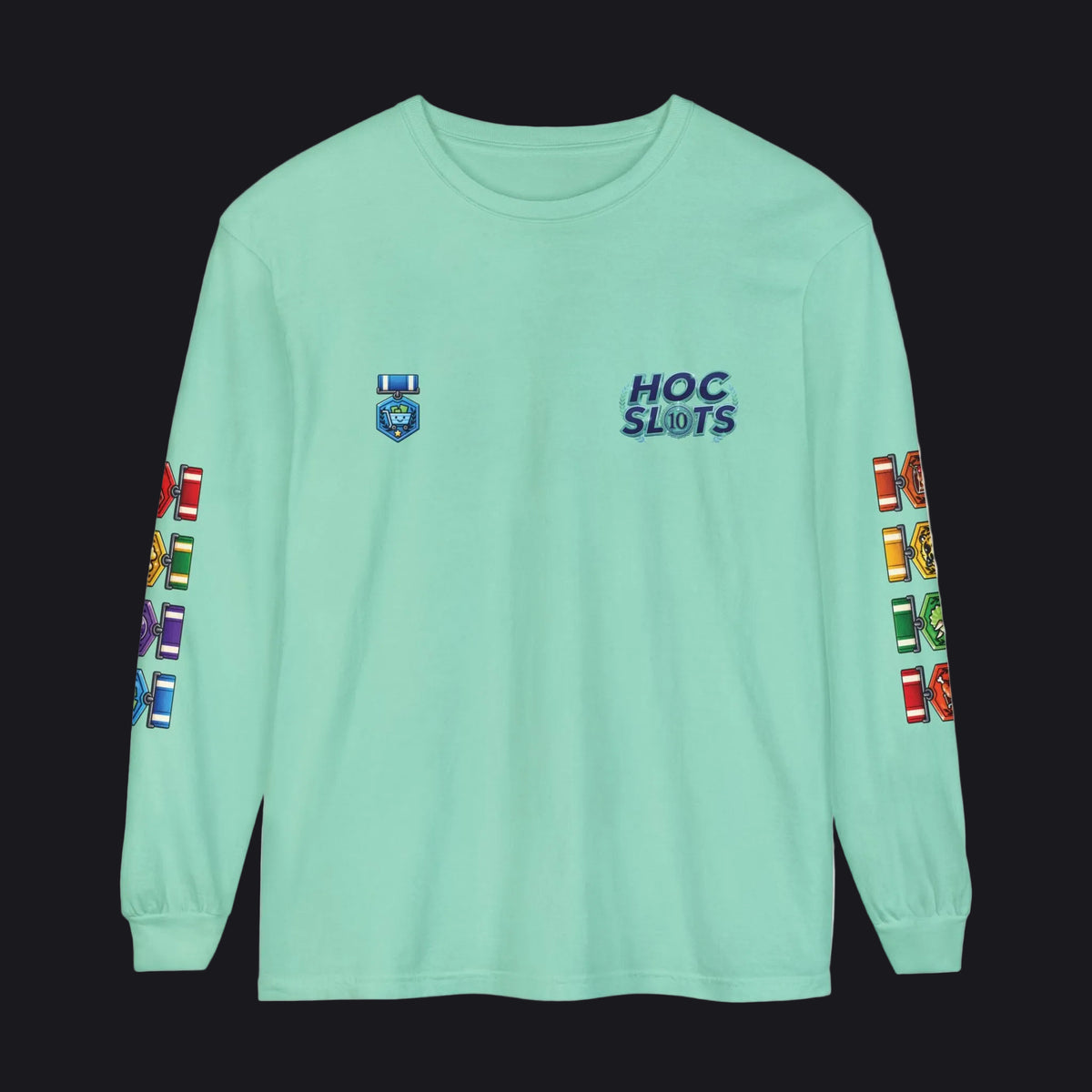 A mint green long-sleeve t-shirt with 'HOC SLOTS' printed in blue on the left chest and colorful graphic prints on both sleeves, shown against a plain white background.