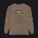A brown long-sleeve t-shirt with a humorous gaming graphic on the back. The graphic features a 'HOC SLOTS 10' logo in a retro video game font, followed by mock '2026 STATS' text detailing high-order gaming achievements.