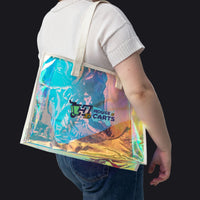 A person wearing a white t-shirt and blue jeans carries a large, semi-transparent holographic tote bag with cream-colored shoulder straps. The bag features a colorful iridescent print with a 'House of Carts' logo printed on the front.