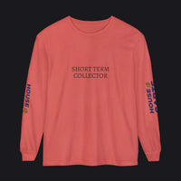 A coral pink long-sleeve t-shirt with 'SHORT TERM COLLECTOR' printed in black serif font on the chest. The left sleeve features 'HOUSE OF CARDS' printed vertically in blue and yellow, and the right sleeve has a small yellow graphic.