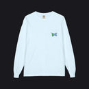A light blue long-sleeve crewneck pocket t-shirt with a small circular graphic printed on the chest pocket, displayed flat against a white background.
