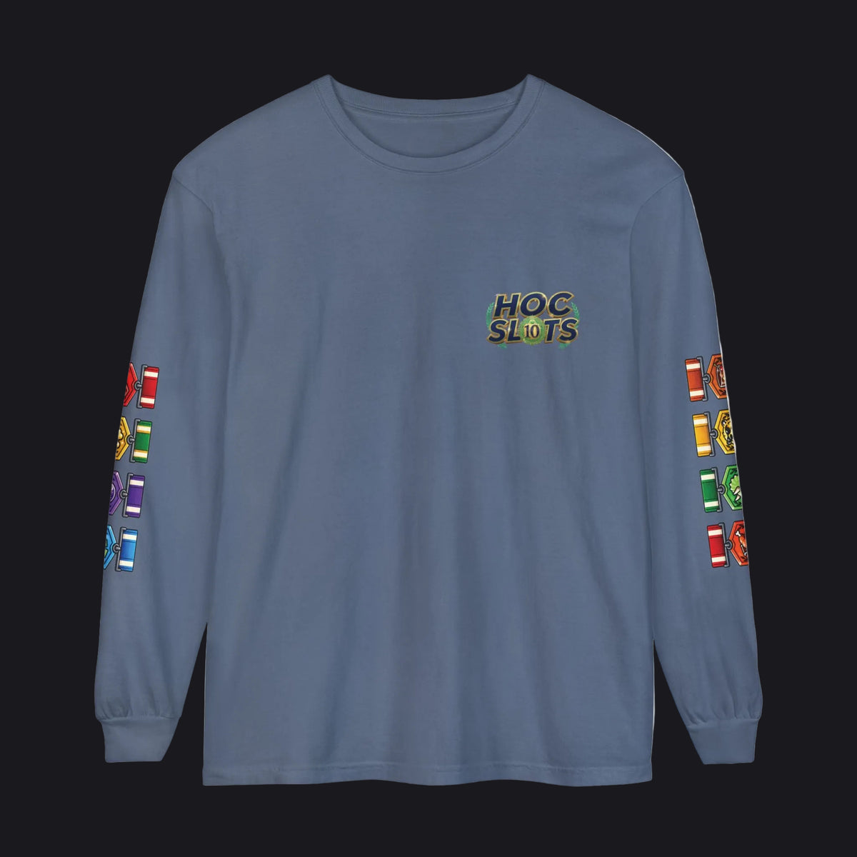 A slate blue long-sleeve t-shirt with a 'HOC SLOTS' graphic on the left chest and colorful slot machine graphics printed down both sleeves, shown against a plain white background.