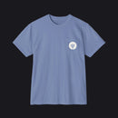A light blue crewneck pocket t-shirt with a small white circular chest graphic showing a power plug icon, displayed on a clean white background.