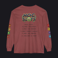 A long-sleeve t-shirt in a dusty rose or mauve color, featuring a 'HOC SLOTS 10' graphic on the back with various gaming statistics printed in black text, and colorful hexagonal patches on both sleeves.