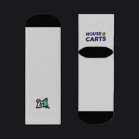 Two white socks with black circular patterns on a white background