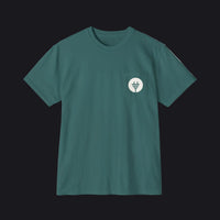 A dark teal green short-sleeve crewneck t-shirt with a small white circular chest pocket graphic featuring a stylized plug icon, displayed on a clean white background.