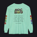 A mint green long-sleeve t-shirt shown from the back, featuring a humorous 'HOC Slots' casino-themed graphic with text detailing high player statistics and colorful hexagonal dice illustrations on the sleeves.