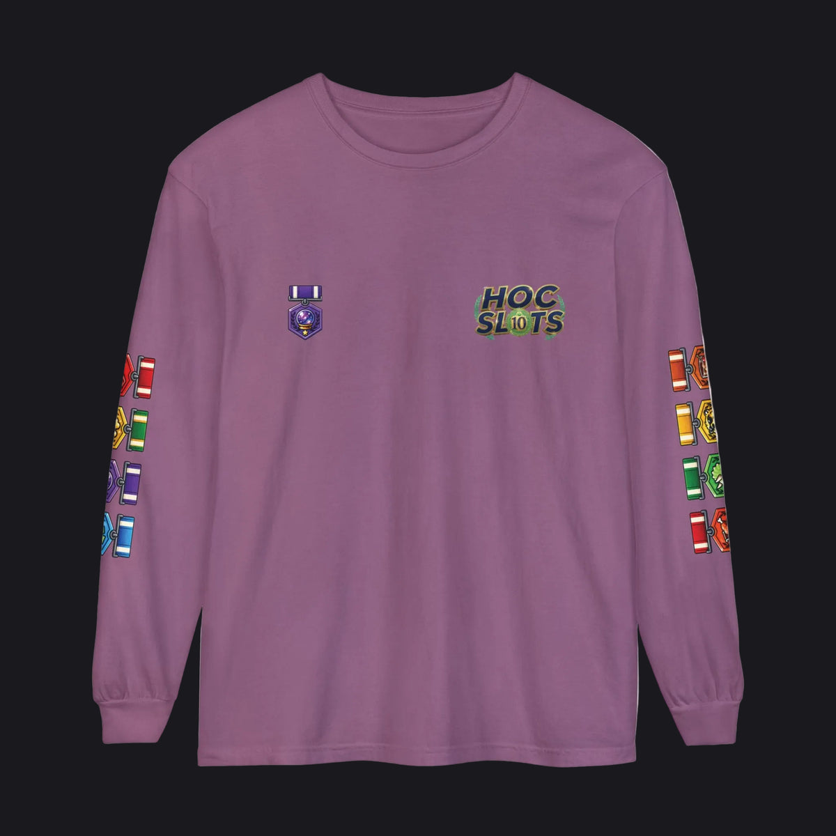 A long-sleeve crewneck t-shirt in dusty purple, featuring a 'HOC SLOTS' graphic on the left chest, a small emblem on the right chest, and colorful military-style insignia printed down both sleeves.