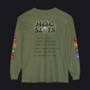 An olive green long-sleeve t-shirt with a humorous 'HOC SLOTS 10' meme graphic printed on the back, featuring mock gaming statistics and colorful hexagonal icons on both sleeves.