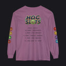 A purple long-sleeve t-shirt with a gaming-themed graphic on the back. The graphic features a 'HOC SLOTS 10' logo in a green and gold gradient, followed by dark gray text displaying various gaming statistics (checkouts, ETD orders, target orders, PKC orders, and a $1,000,000 at MSRP).