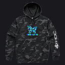 A black and gray camouflage hoodie featuring a blue and green shopping cart graphic with the text 'HOUSECARTS' on the chest, and a white PlayStation logo printed vertically on the right sleeve.