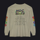 A beige long-sleeve t-shirt with a detailed graphic on the back. The graphic features a colorful 'HOC SLOTS 10' logo at the top, followed by pixel-style text detailing game statistics (including '2026 STATS' and '$1,000,000 AT MSRP').