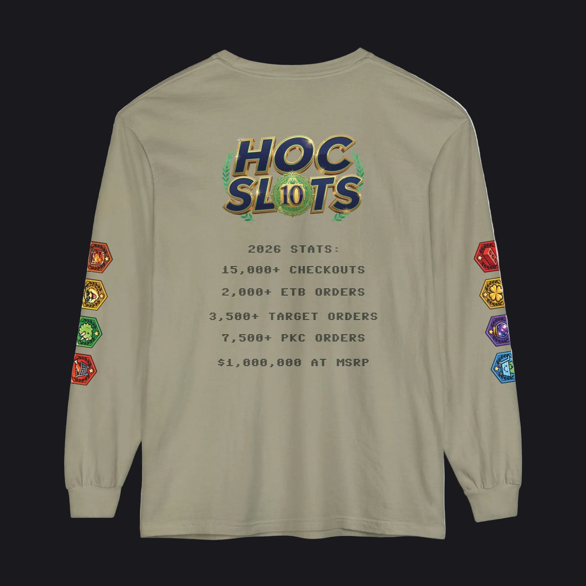 A beige long-sleeve t-shirt with a detailed graphic on the back. The graphic features a colorful 'HOC SLOTS 10' logo at the top, followed by pixel-style text detailing game statistics (including '2026 STATS' and '$1,000,000 AT MSRP').