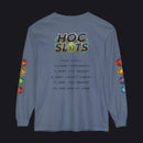 A blue long-sleeve t-shirt with a gaming-themed graphic on the back. The graphic features a 'HOC SLOTS 10' logo in a retro video game font, followed by fake statistics in black text, and colorful hexagonal icons printed down both sleeves.