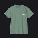 A sage green short-sleeve crewneck pocket t-shirt with 'HOC' printed in white on the chest pocket, shown flat on a white background.