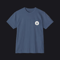 A slate blue crewneck pocket t-shirt with a small white circular chest graphic, displayed flat against a clean white background.