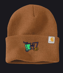 A brown ribbed knit beanie hat featuring a folded cuff with a colorful embroidered graphic and a white Carhartt brand patch on the side.