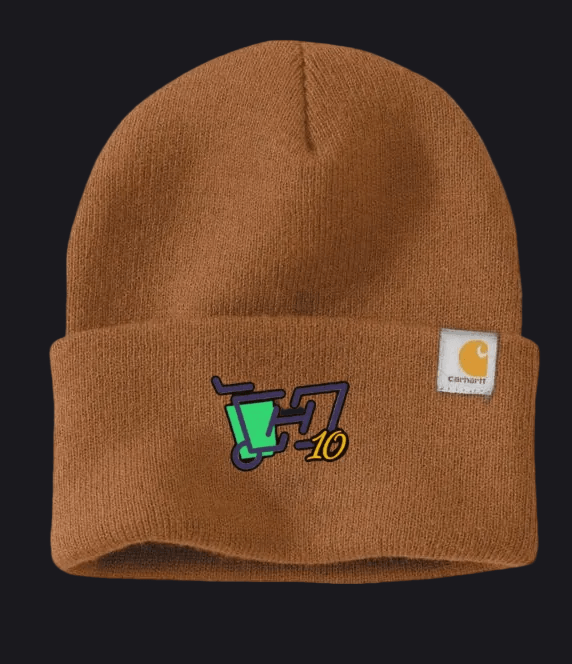 A brown ribbed knit beanie hat featuring a folded cuff with a colorful embroidered graphic and a white Carhartt brand patch on the side.