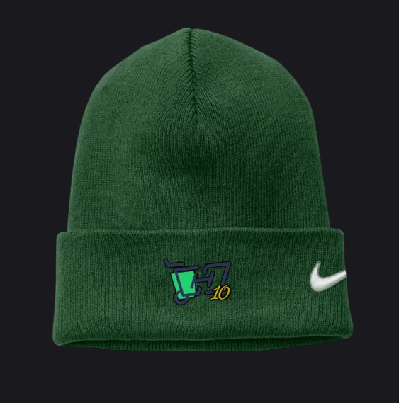 A dark green knit beanie with a folded cuff, featuring a white Nike swoosh on the right side and a custom graphic on the left. The graphic includes a teal and purple cart, the number 10, and a small yellow accent.