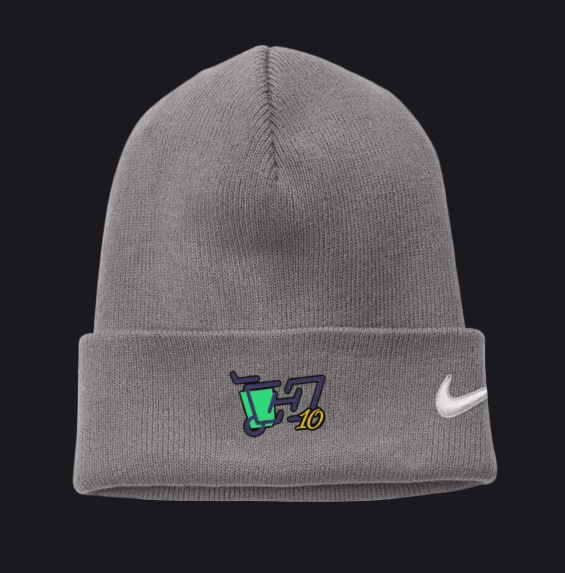 A gray ribbed knit beanie hat featuring a white Nike swoosh on the cuff and a small embroidered graphic with a green trash can, dark blue lettering, and yellow '10' on the front left.