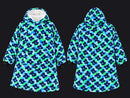 Front and back views of a hooded sweatshirt featuring a blue, green, and navy floral camouflage pattern, with a white fleece-lined hood and black cuffs.