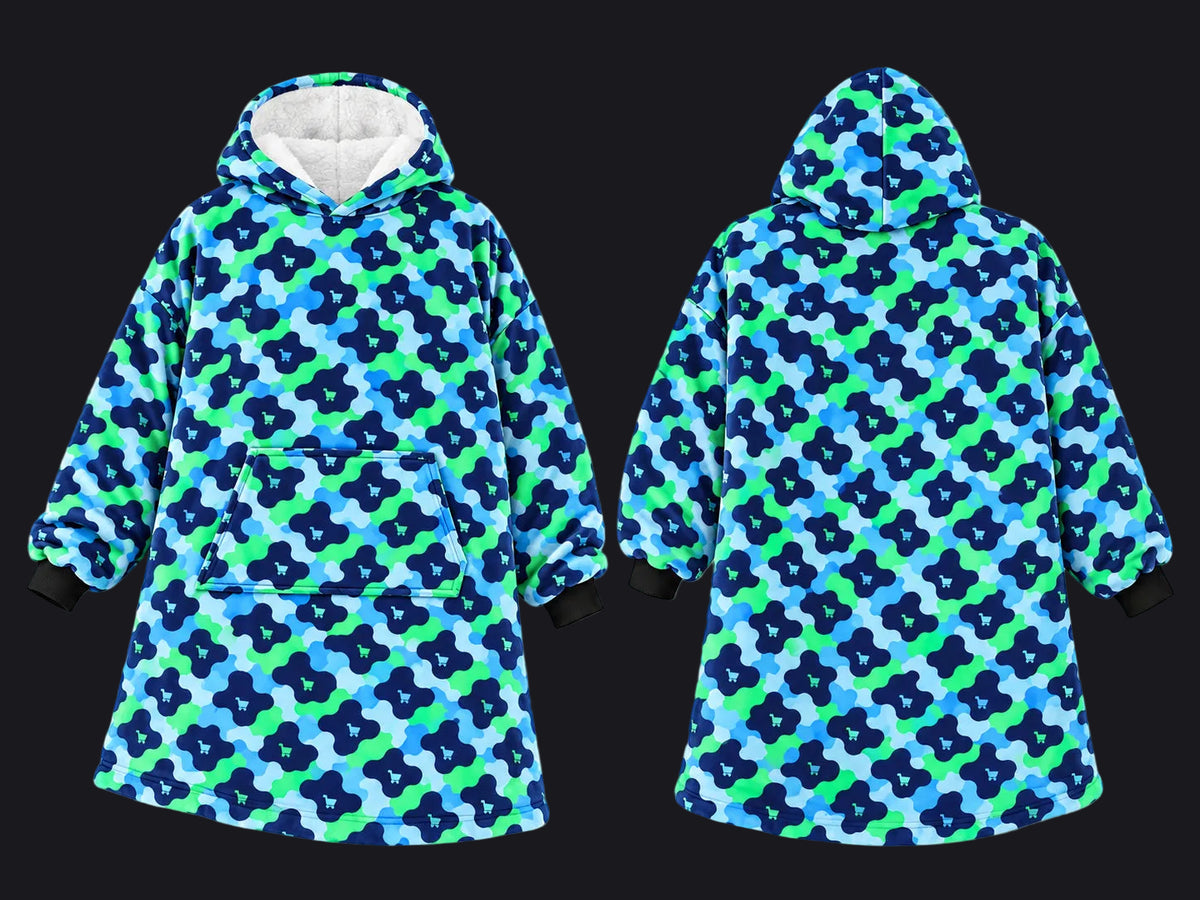 Front and back views of a hooded sweatshirt featuring a blue, green, and navy floral camouflage pattern, with a white fleece-lined hood and black cuffs.