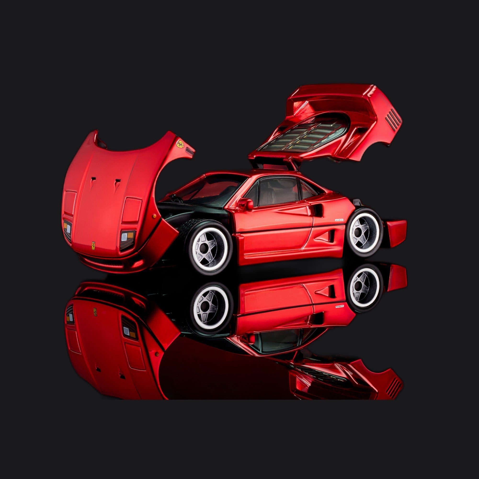 Both body panels open, seen from the front left, with the cabin and Real Riders wheels between them.