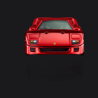 Head-on front view, headlight covers down, Ferrari shield sitting above the mesh lower grille.