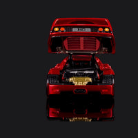 Rear view with the clamshell raised, F40 badge plate and round taillights above the gold exhaust.